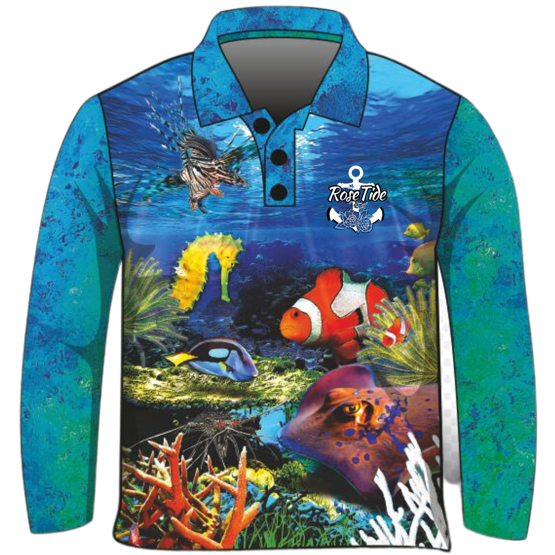 A long-sleeve women's and children's fishing shirt featuring a vibrant underwater scene with various sea creatures, including a lionfish, seahorse, clownfish, and stingray. The background transitions from deep blue water to a colourful coral reef at the bottom. The "Rose Tide" logo with an anchor and floral design is displayed on the chest.