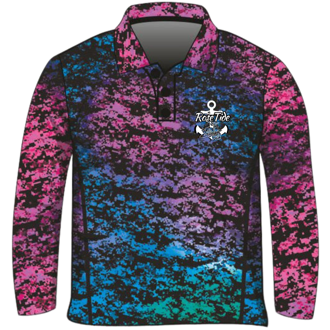 A long sleeve women's fishing shirt with a digital camouflage pattern in vibrant colors, including pink, purple, blue, and green. The shirt features the "Rose Tide" logo with an anchor and floral design on the chest. The overall design is bold and eye-catching.