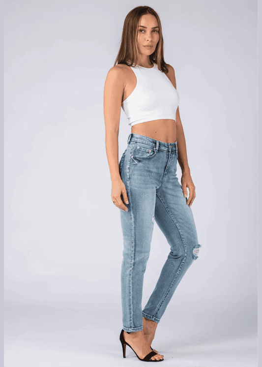 Woman wearing Light Wash Distressed Mom Jeans with High-waist subtle ripped knee in a stylish Light Wash.  Jeans for Women