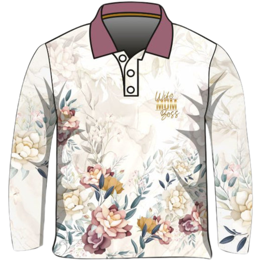 A cream-coloured long-sleeve Fishing Sun shirt adorned with floral patterns in soft pastel tones. The shirt features bold gold text in the centre that reads "Wife Mum Boss." The shirt has a buttoned collar and is labelled as "Wife Mum Boss - Floral."